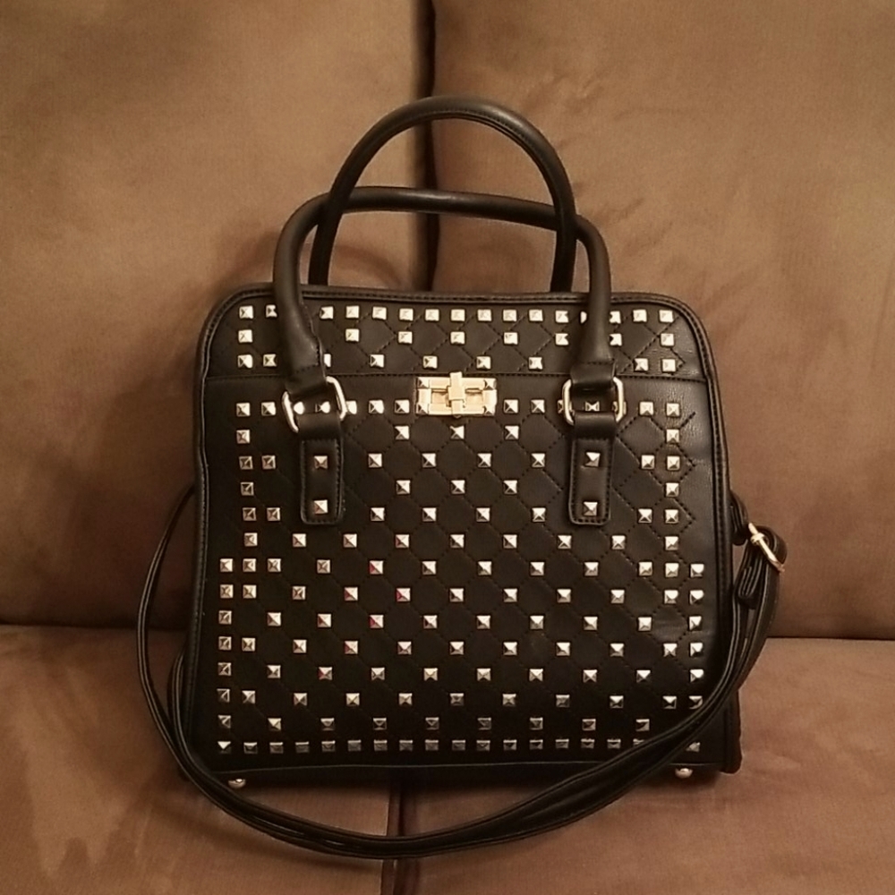 Black handbag with gold studs and hardware